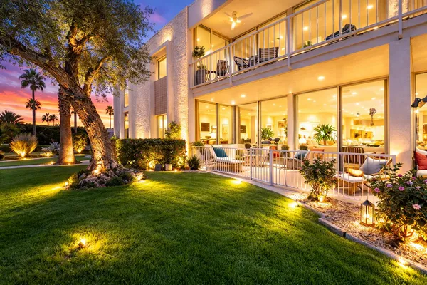 a swimming pool with outdoor seating and yard