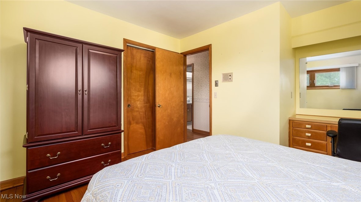 165 Old Rix Mills Road New Concord, OH 43762 - Photo 12 of 34 Bedroom with a closet and wood finished floors