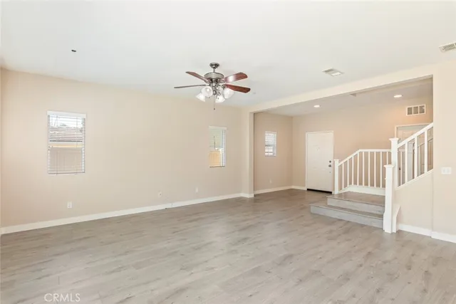 a large kitchen with a large counter top a sink stainless steel appliances and cabinets