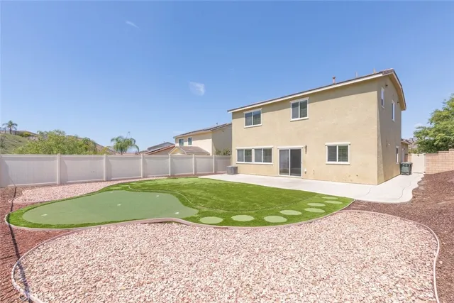 an aerial view of residential houses with outdoor space and trees all around