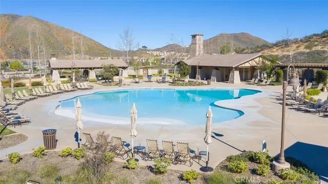 a roof deck with table and chairs under an umbrella
