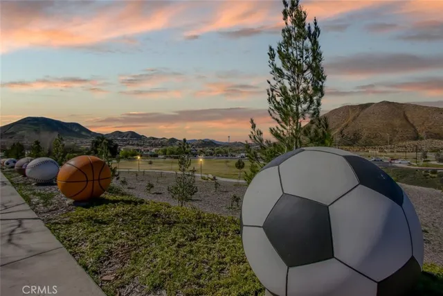 an aerial view of residential houses with outdoor space and parking