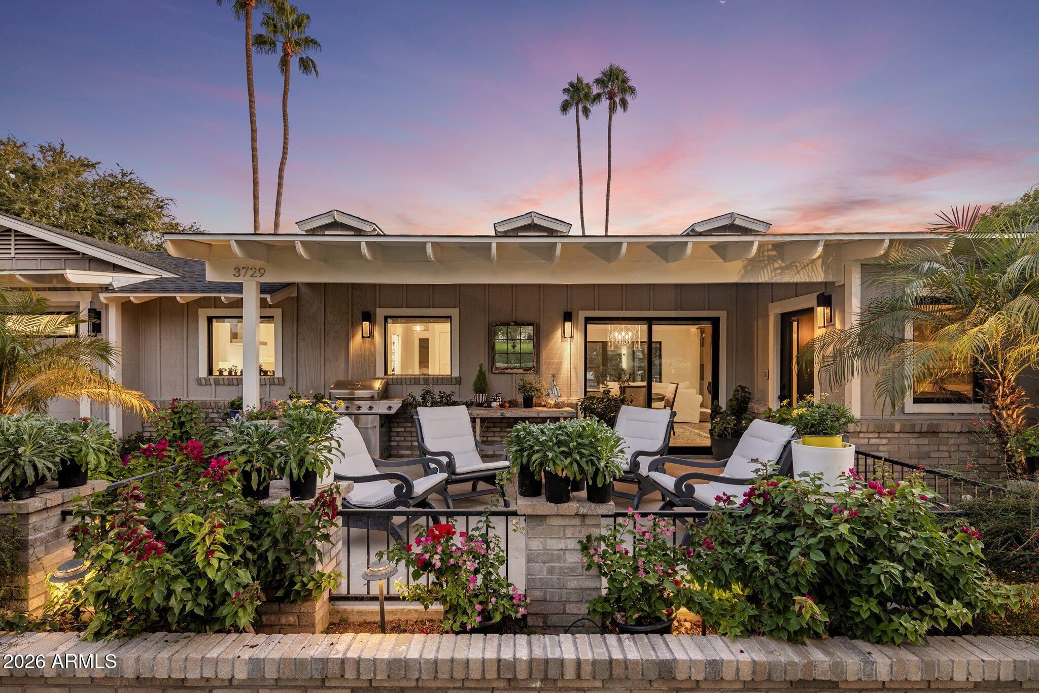 a front view of a house with lots of potted plants