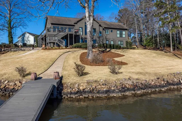 a view of a house with backyard and porch