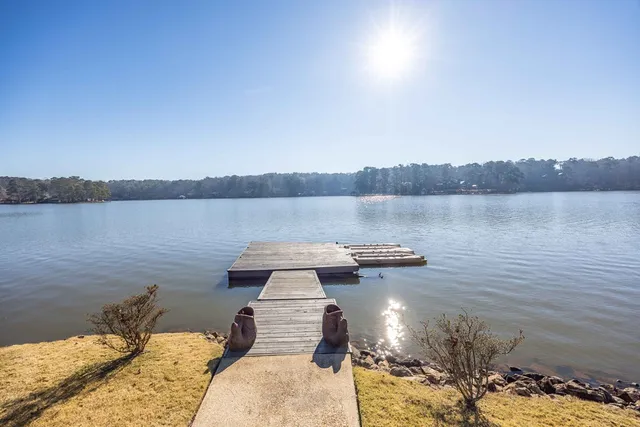 a view of a house with swimming pool next to a yard