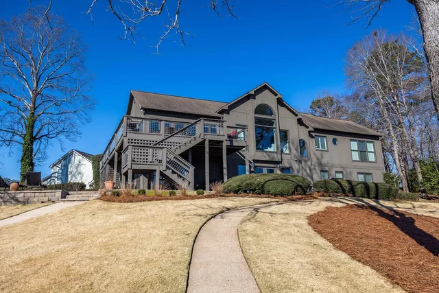 a dining room with furniture a chandelier and wooden floor