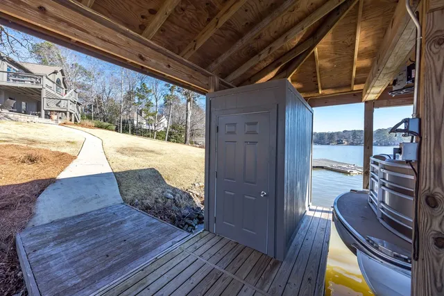 a large kitchen with kitchen island a large counter space a large window and stainless steel appliances