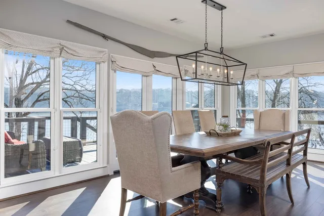 a living room with furniture a flat screen tv and a large window