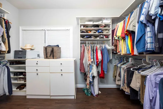 a view of a backyard with couches chair and potted plants