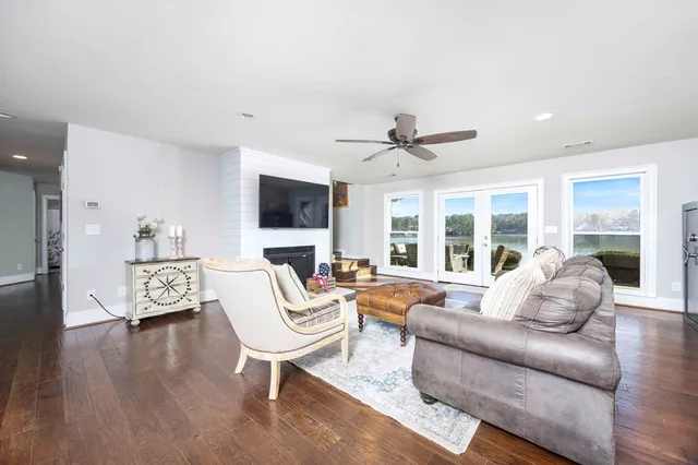 a backyard of a house with lots of green space and lake view