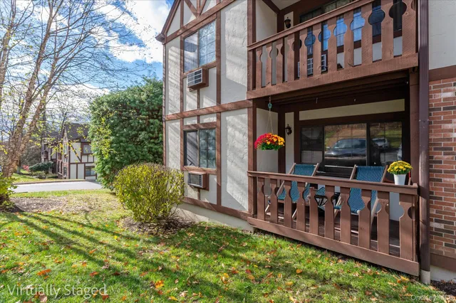a view of a house with wooden deck front of house