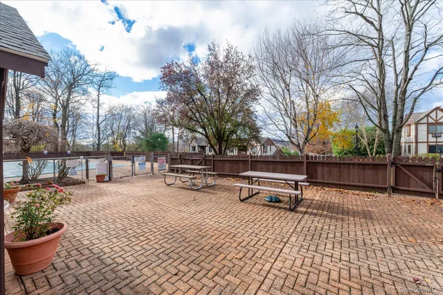 a park view with a bench and trees