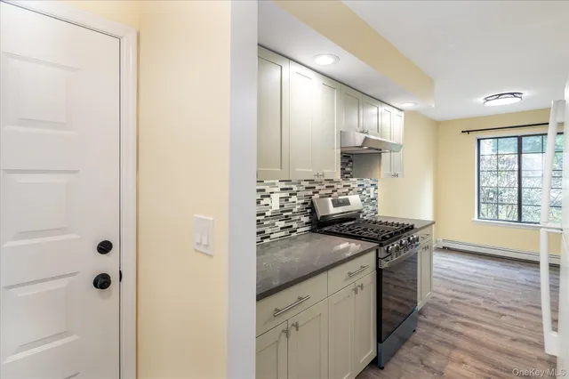 a kitchen with stainless steel appliances granite countertop a stove and a sink