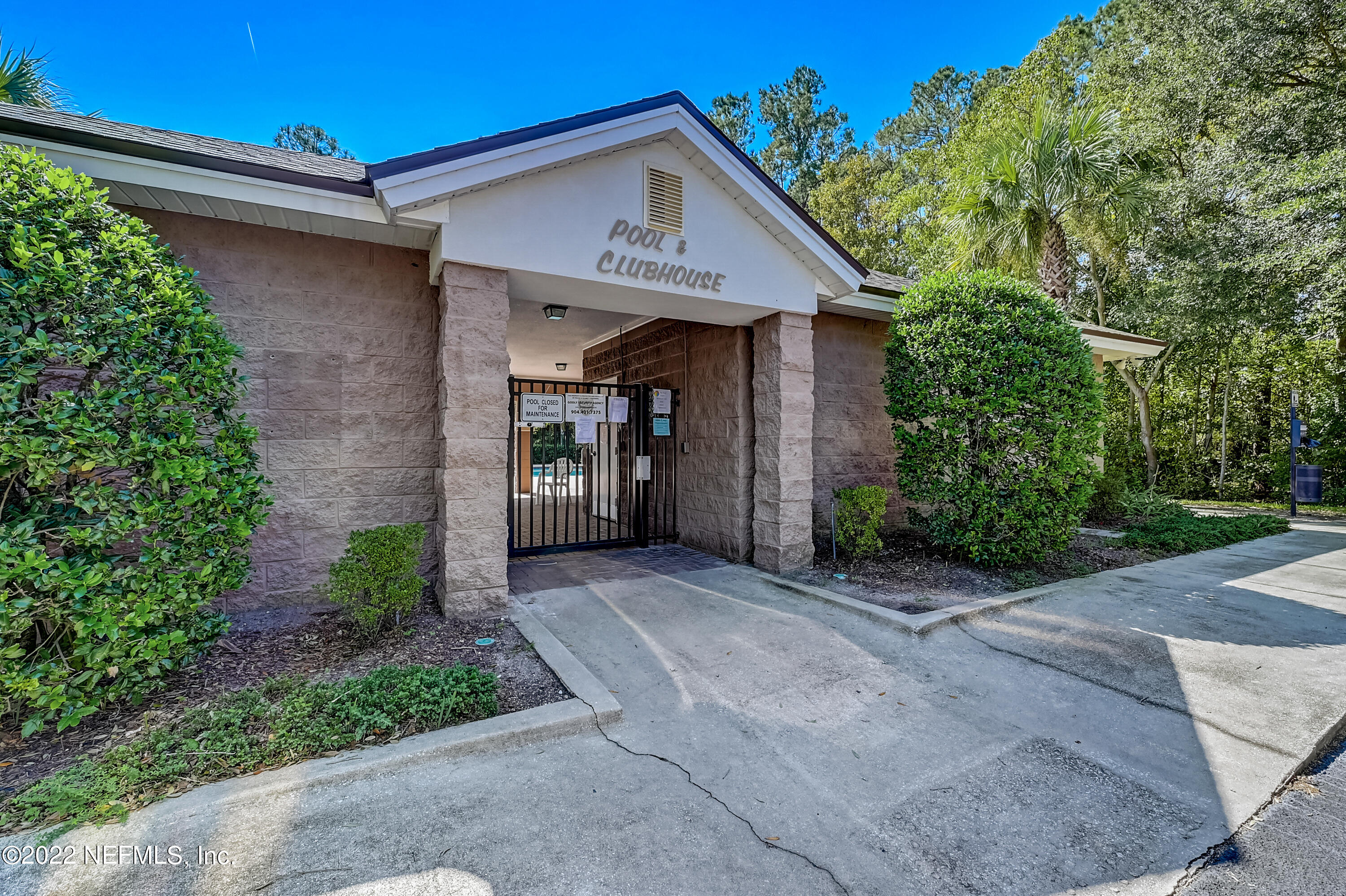 7920 Merrill Road, Unit 712 Jacksonville, FL 32277 - Photo 24 of 28 a front view of a house with yard and trees