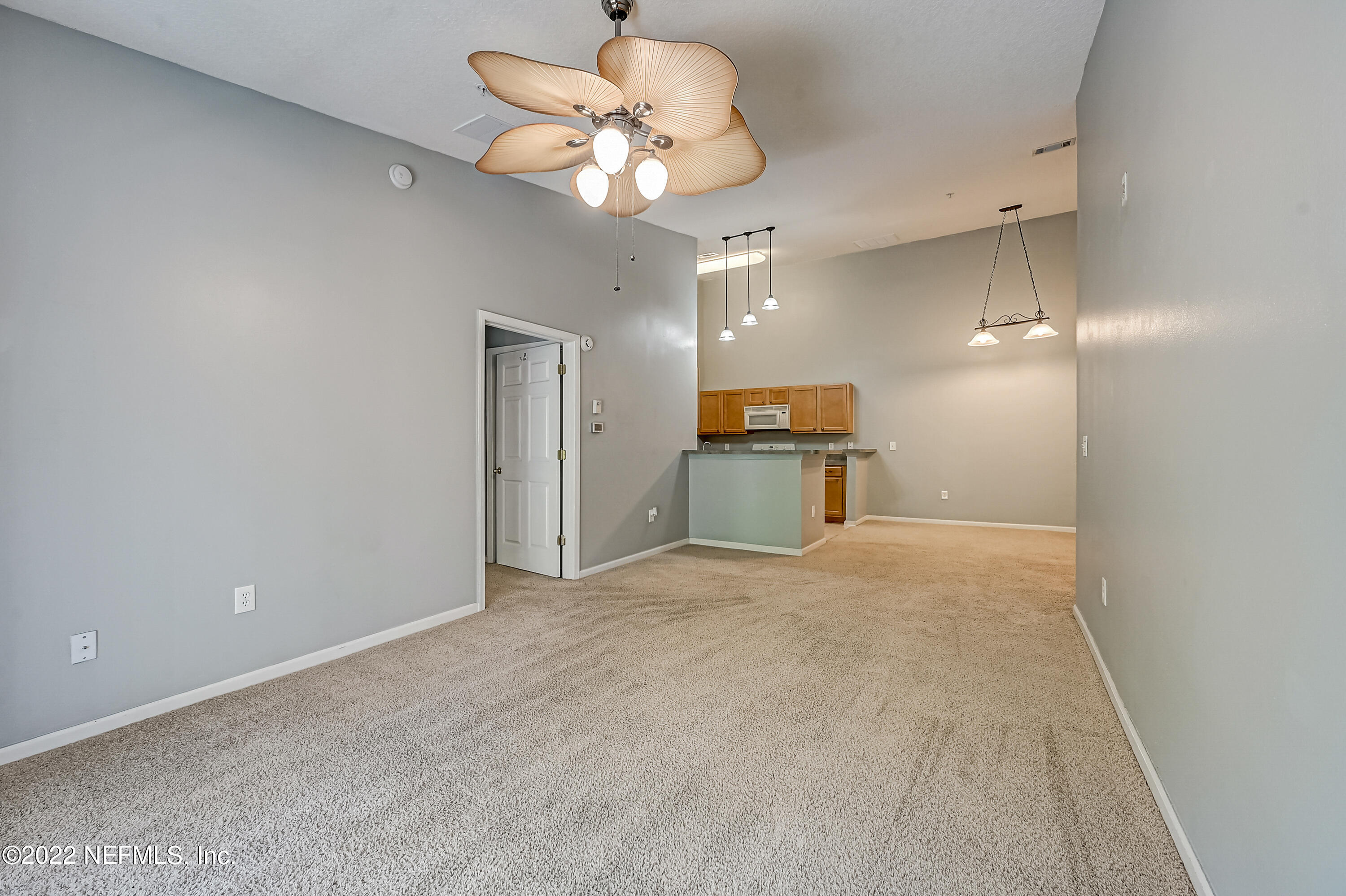 7920 Merrill Road, Unit 712 Jacksonville, FL 32277 - Photo 7 of 28 a view of a kitchen with a sink and a refrigerator