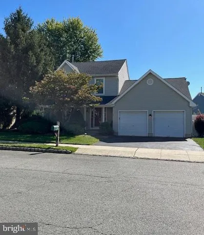 a house with a yard and a large parking space