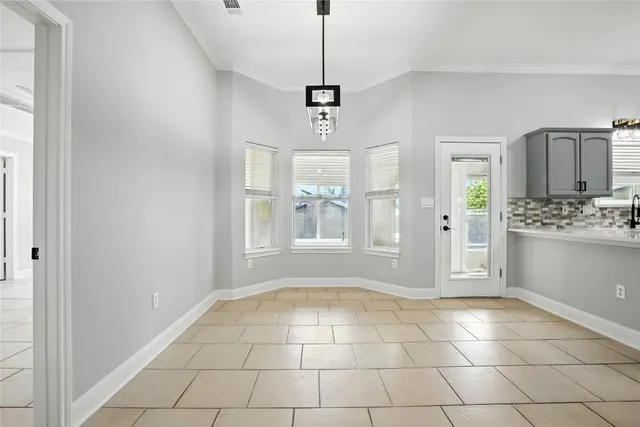 a view of an empty room with window and cabinet