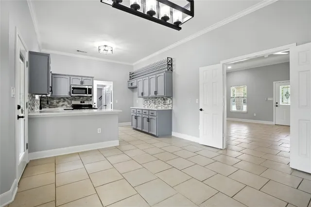 a kitchen with stainless steel appliances a refrigerator sink and microwave