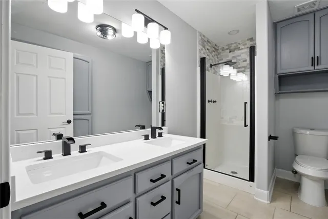 a bathroom with a sink double vanity and a mirror