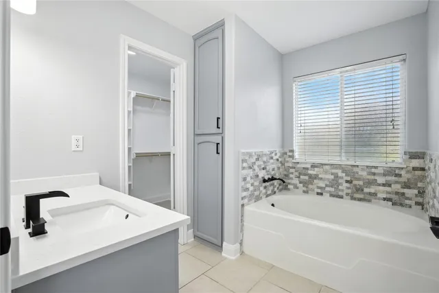 a bathroom with a bathtub and a sink