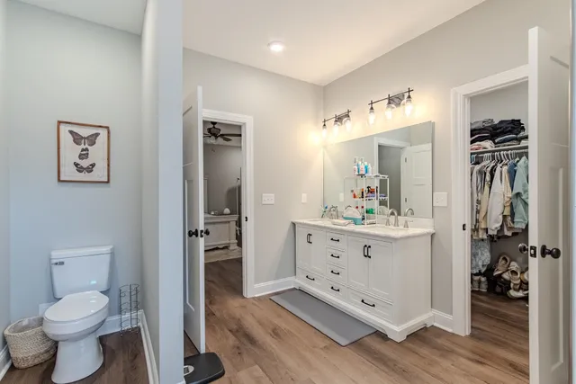 a bathroom with a toilet a sink and glass door