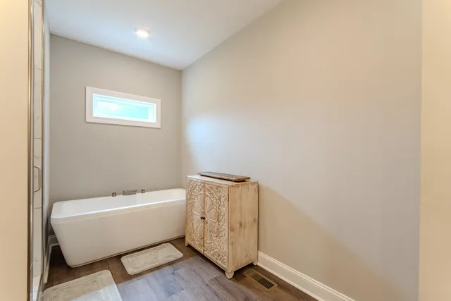 a bathroom with a bathtub and shower