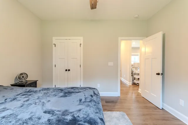 a bedroom with a bed and wooden floor