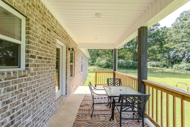 a view of a chairs and table in the balcony