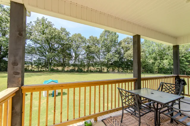 a view of a chairs and table in the balcony