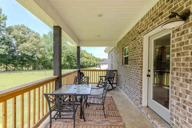 a view of a chairs and table in the balcony