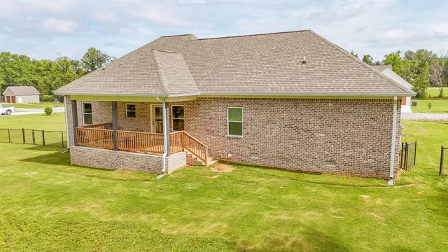 a view of a house with backyard and a garden