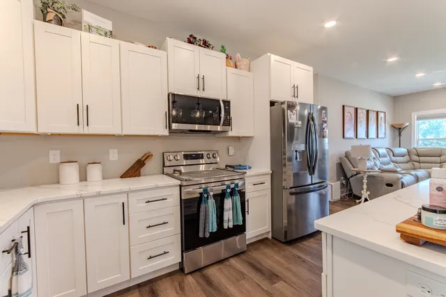 a kitchen with stainless steel appliances a stove refrigerator sink and microwave