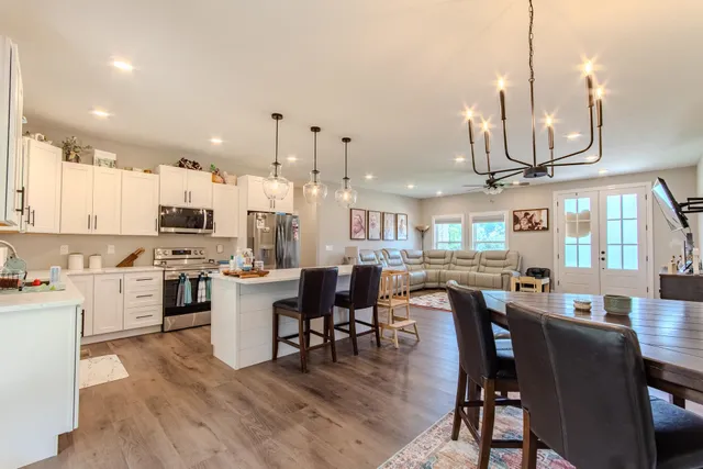 a large kitchen with a table and chairs