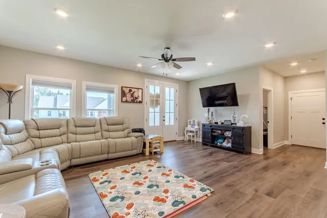 a living room with furniture and a flat screen tv