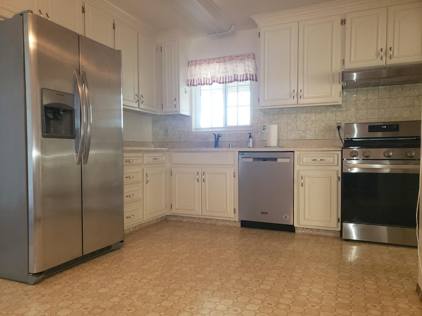 562 Leslie Drive Salinas, CA 93906 - Photo 8 of 21 a kitchen with a sink stainless steel appliances and cabinets