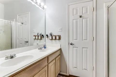 125 Timber Cross Court Azle, TX 76020 - Photo 11 of 17 a bathroom with double vanity and a mirror