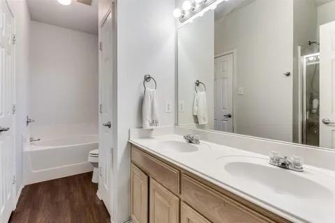 125 Timber Cross Court Azle, TX 76020 - Photo 7 of 17 a bathroom with a tub sink and a mirror
