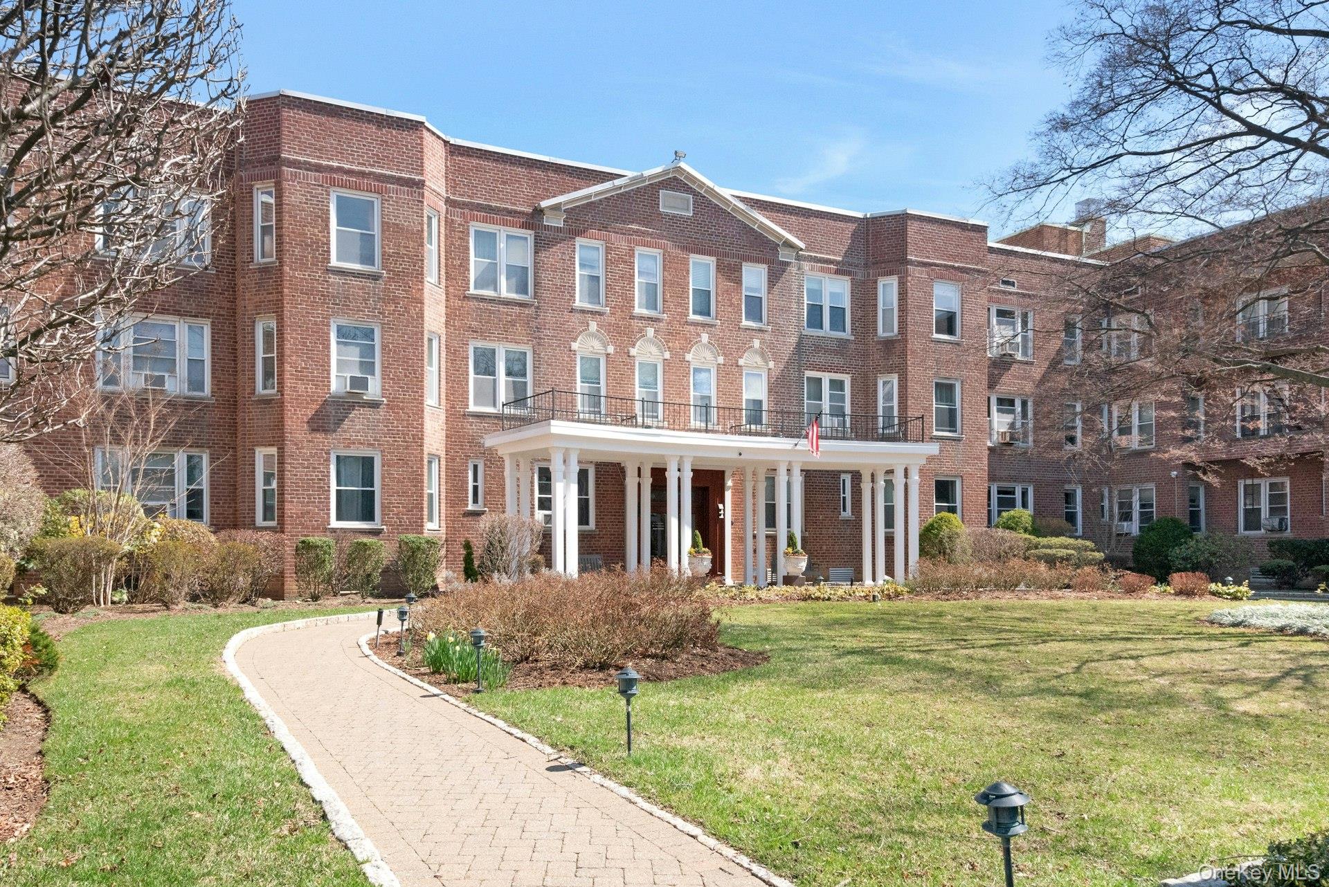 101 Old Mamaroneck Road, Unit 2C5 White Plains, NY 10605 - Photo 1 of 35 a front view of a residential apartment building with a yard