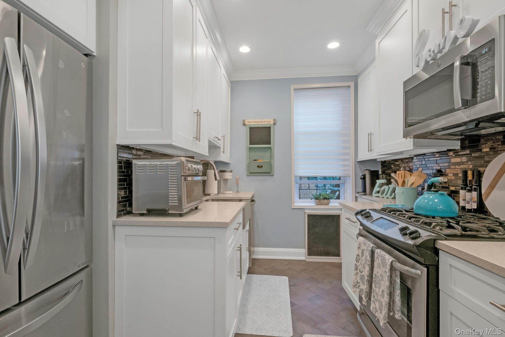 101 Old Mamaroneck Road, Unit 2C5 White Plains, NY 10605 - Photo 12 of 35 a kitchen with stainless steel appliances granite countertop a refrigerator stove and sink