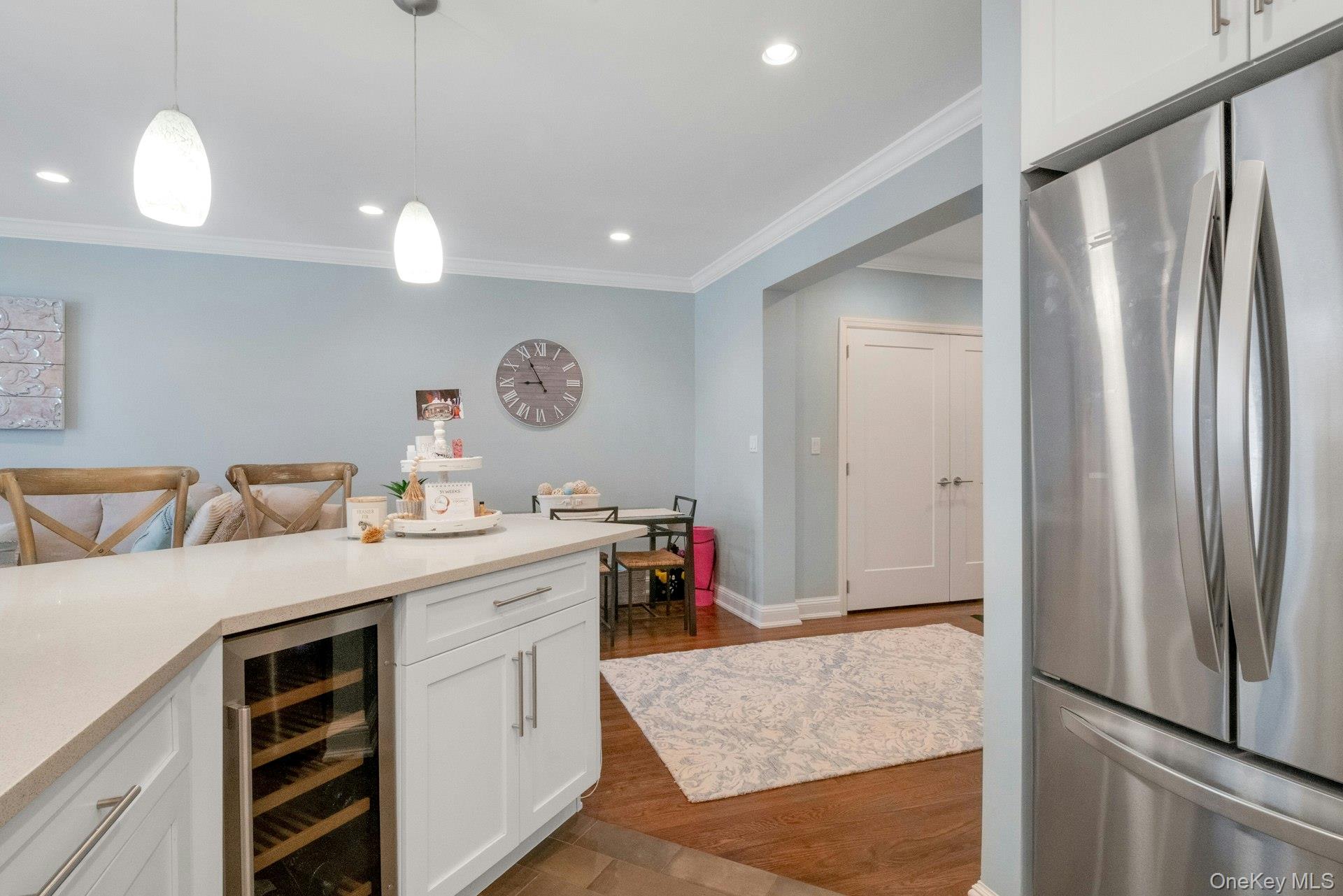 101 Old Mamaroneck Road, Unit 2C5 White Plains, NY 10605 - Photo 15 of 35 a hall with kitchen island white cabinets and stainless steel appliances