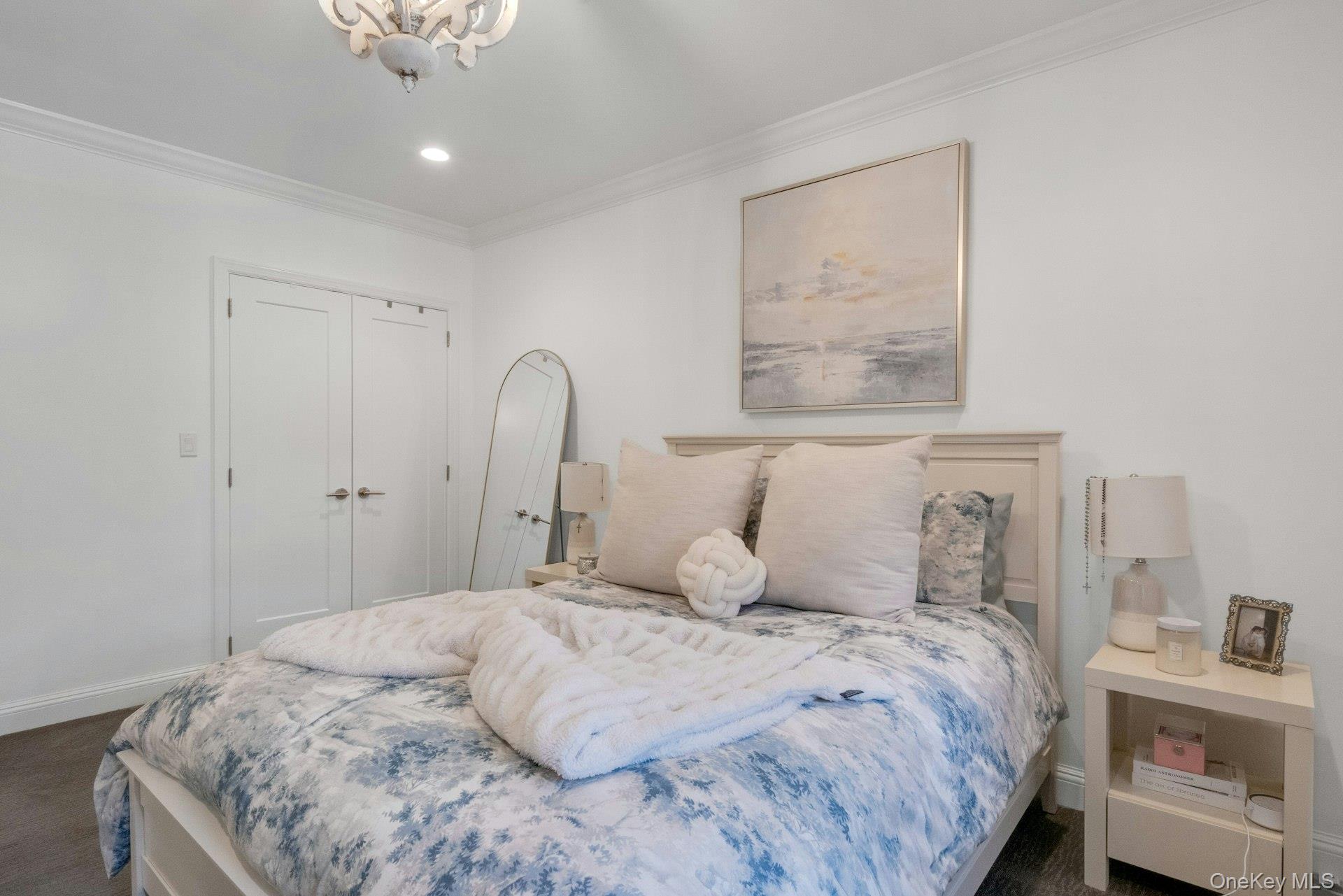 101 Old Mamaroneck Road, Unit 2C5 White Plains, NY 10605 - Photo 24 of 35 a bedroom with a bed and a painting on the wall