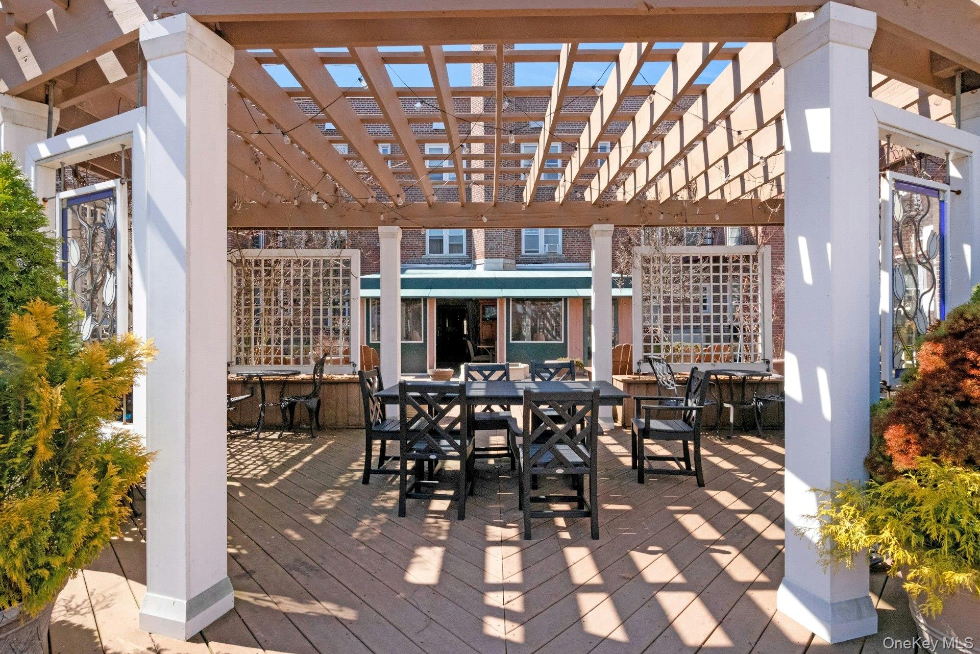 101 Old Mamaroneck Road, Unit 2C5 White Plains, NY 10605 - Photo 33 of 35 a view of a patio with table and chairs and potted plants