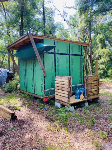 a view of a small house with a yard