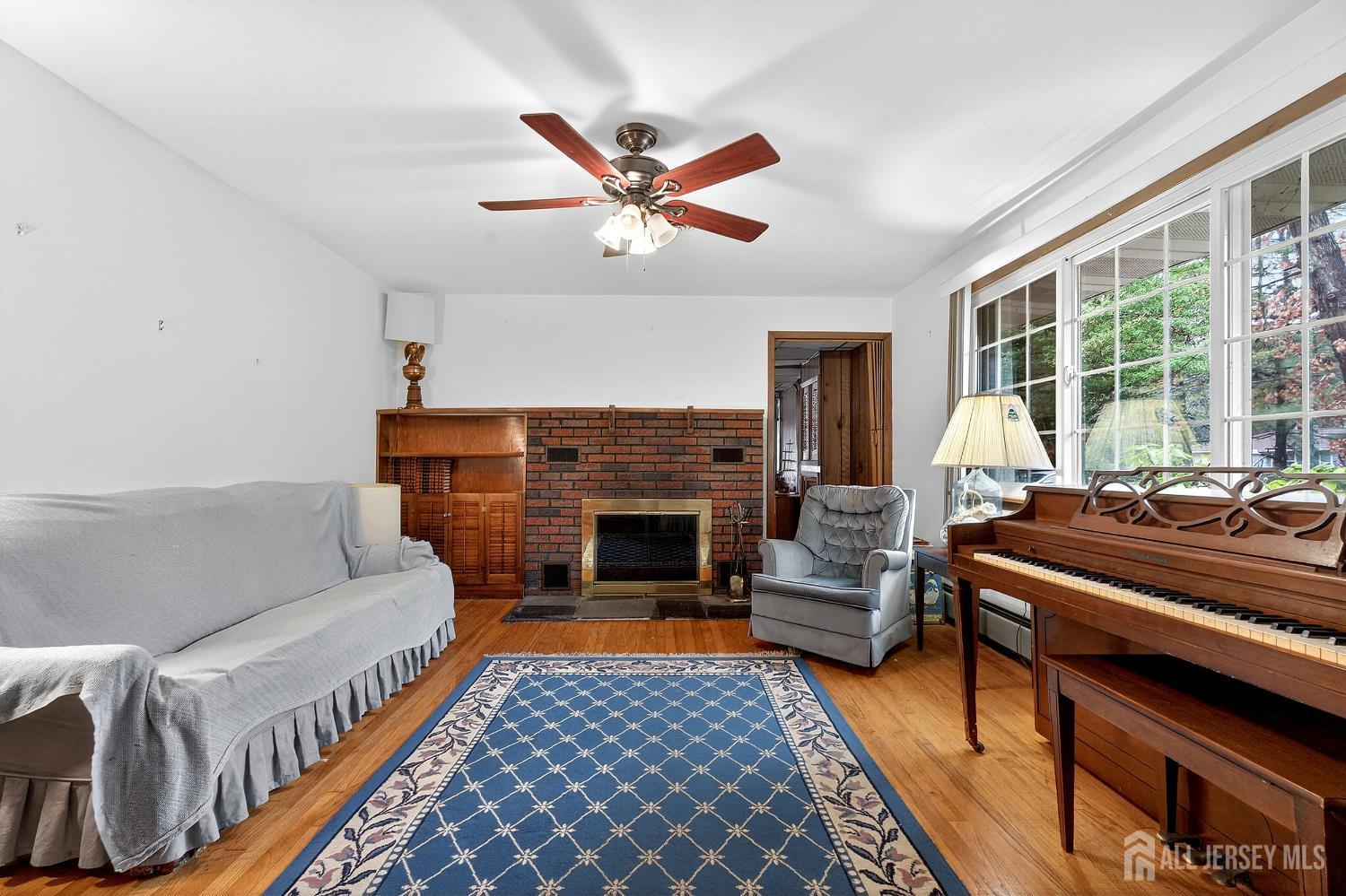 21 Pine Street Old Bridge, NJ 08857 - Photo 4 of 31 a living room with furniture a fireplace and a large window