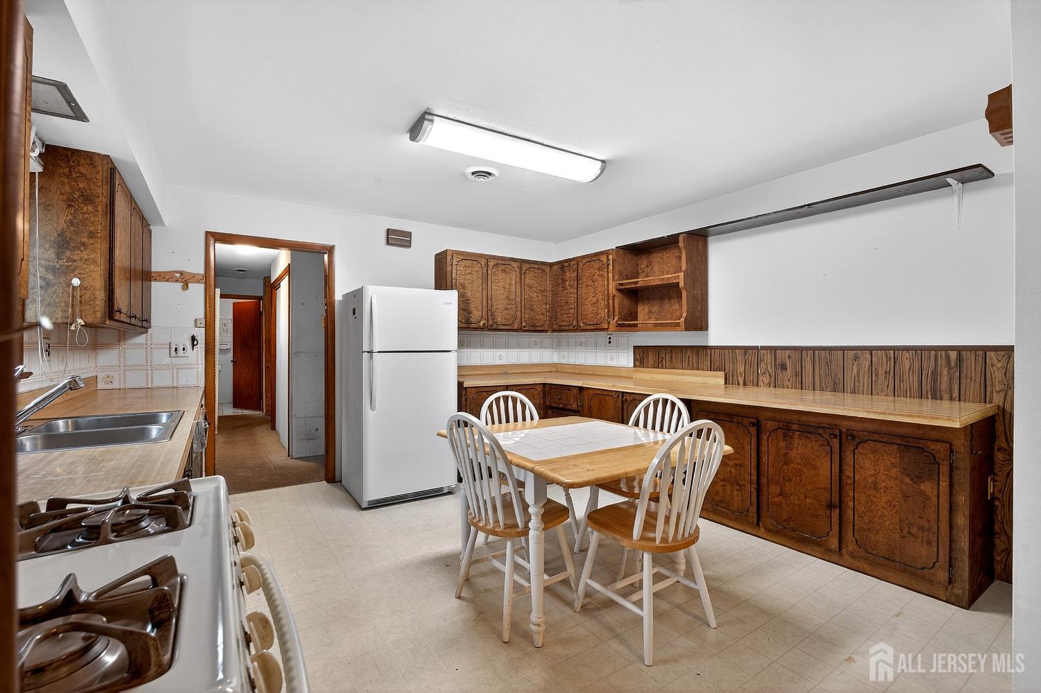 21 Pine Street Old Bridge, NJ 08857 - Photo 7 of 31 a kitchen with a table and chairs in it