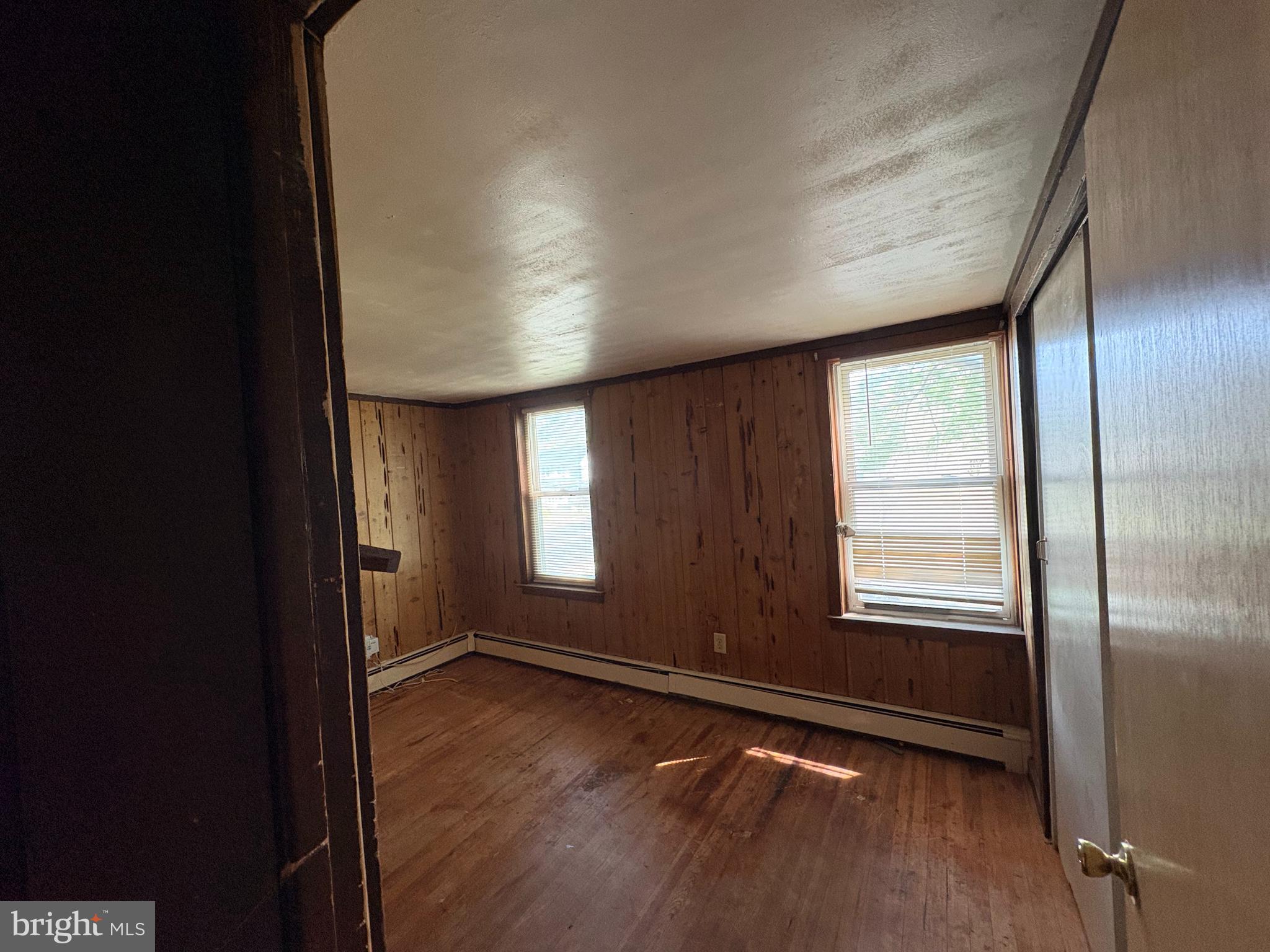 1405 Pennington Road, Unit 2A Ewing, NJ 08618 - Photo 4 of 12 an empty room with wooden floor and windows