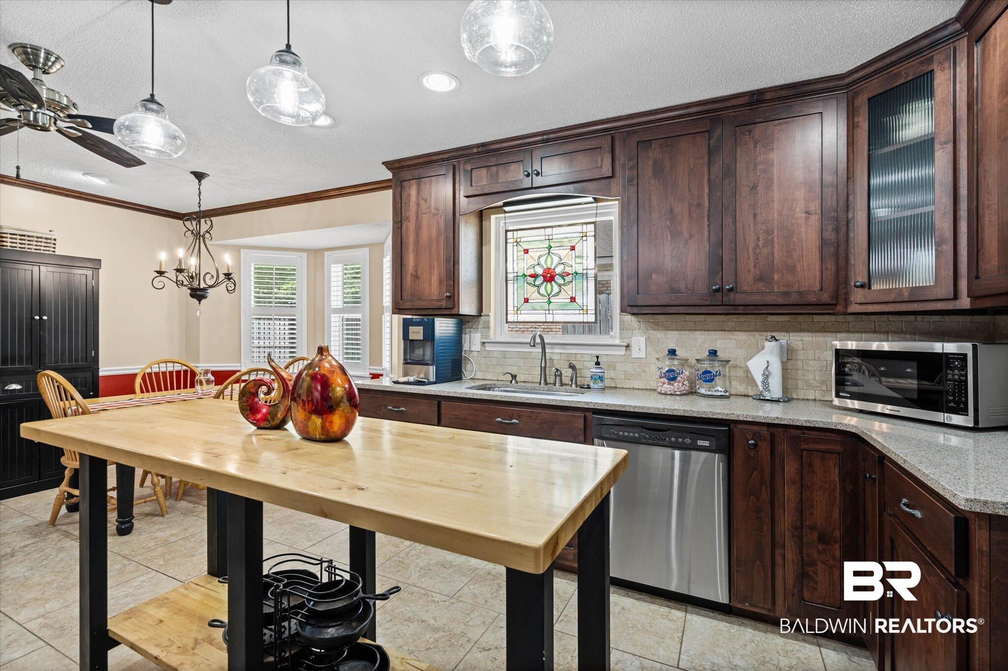 7410 Smithfield Road East Mobile, AL 36695 - Photo 9 of 24 Kitchen featuring wood cabinetry, light-toned countertops, and stainless steel appliances