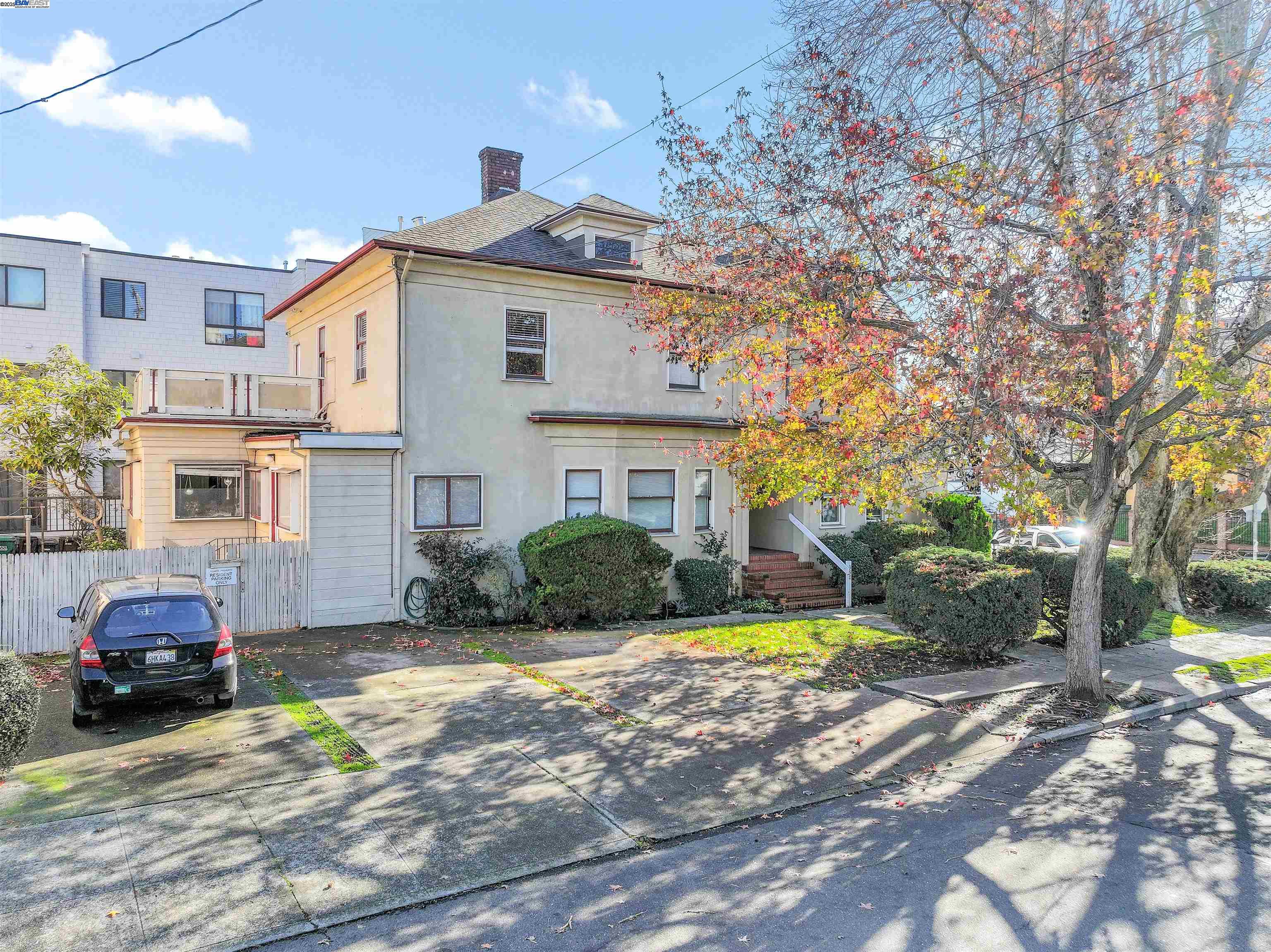 a view of a car parked in front of a brick house