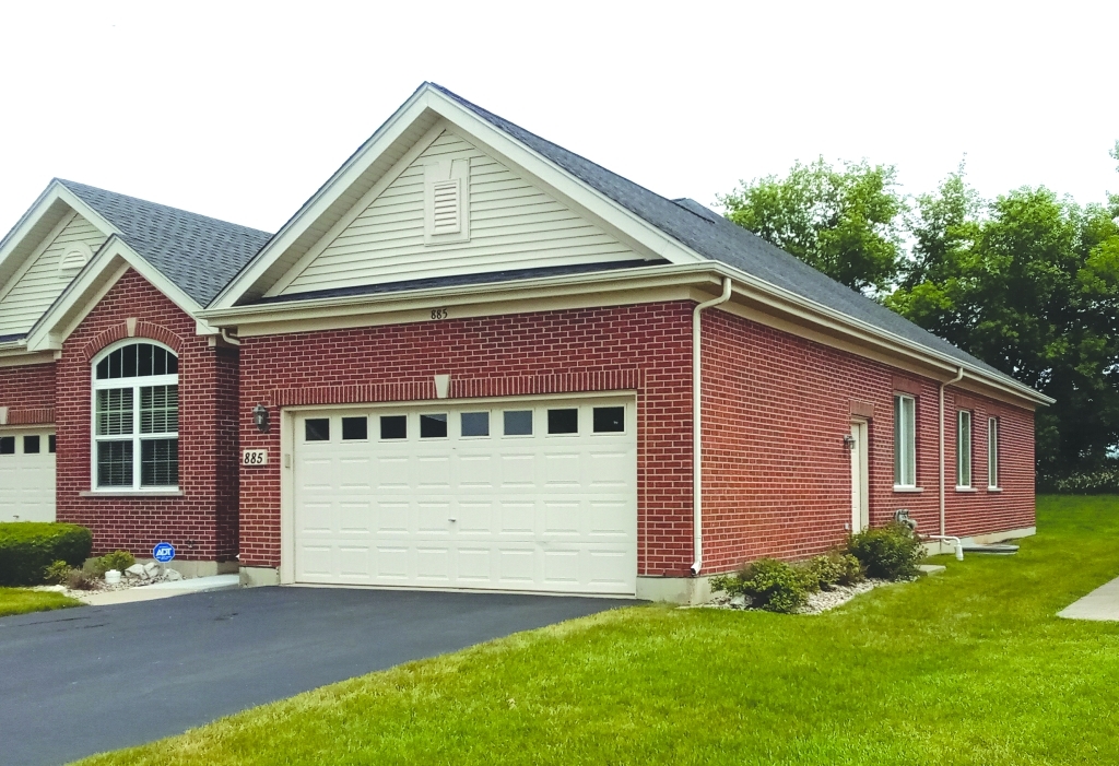 885 Eineke Boulevard Algonquin, IL 60102 - Photo 2 of 16 a front view of a house with a garden and plants