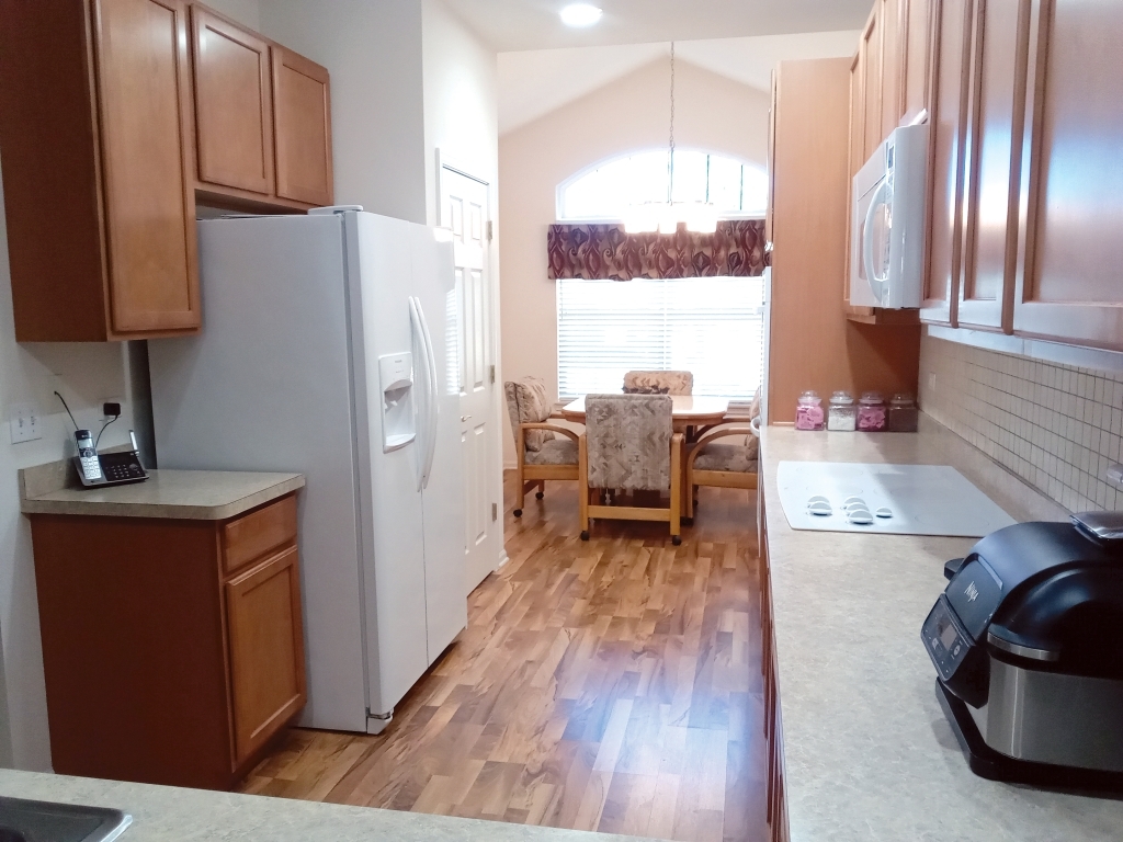 885 Eineke Boulevard Algonquin, IL 60102 - Photo 7 of 16 a kitchen with stainless steel appliances granite countertop a refrigerator sink and wooden floor